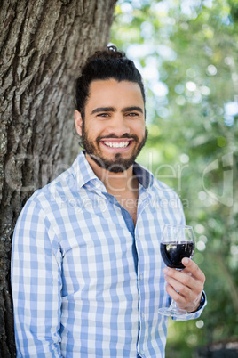 Man holding glass of wine in the park