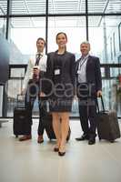 Businesspeople standing together with luggage
