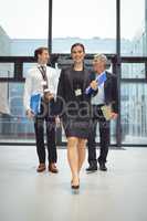 Businesspeople walking together with file