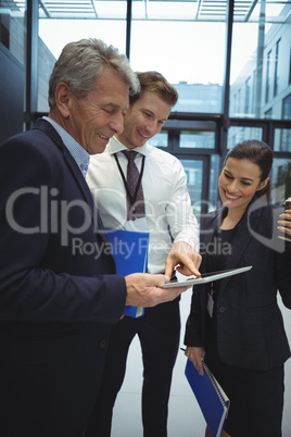 Businesspeople using digital tablet