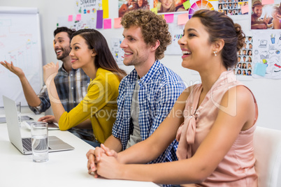 Executives listening presentation in conference room at office