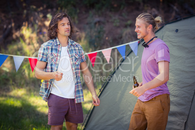 Friends interacting with each other at campsite