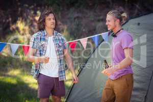 Friends interacting with each other at campsite