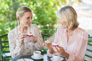 Smiling friends enjoying coffee together