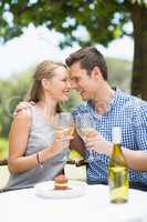 Couple toasting glasses of wine in a restaurant