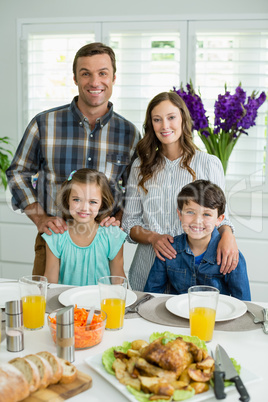 Portrait of smiling family having lunch together on dining table