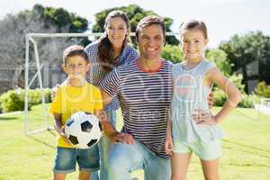 Family playing football together at the park