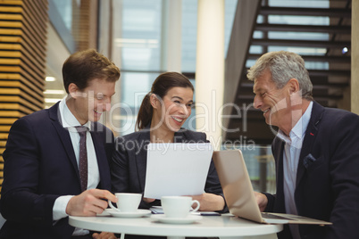 Businesspeople discussing over a paper document