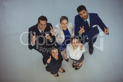 Successful businesspeople showing victory sign