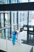 Female doctor and nurse examining x-ray report