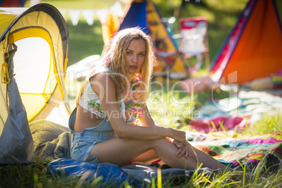 Beautiful woman sitting at campsite