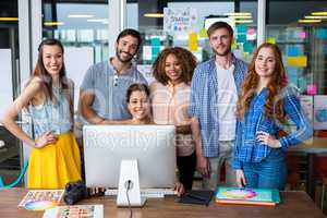 Smiling graphic designers working at desk in office