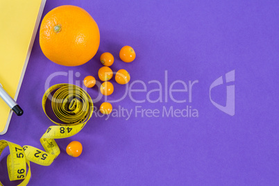 Citrus fruit with vegetable and measuring tape