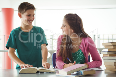 School kids doing homework in library at school