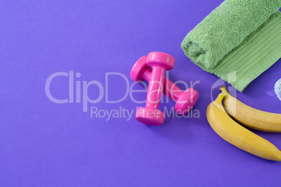 Dumbbells with banana and towel