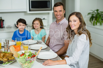 Portrait of smiling family having lunch together on dining table