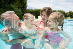 Parents and kids having fun in poolside