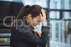 Depressed businesswoman with hand on her head