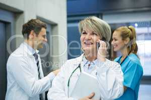 Female doctor talking on mobile phone