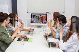 Business team having video conference with another business team