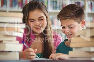 School kids doing homework in library at school