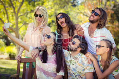 Group of friends taking selfie with mobile phone