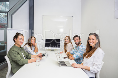 Portrait of smiling executive in conference room during meeting