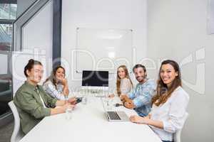 Portrait of smiling executive in conference room during meeting