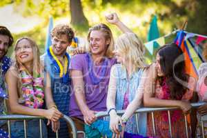 Friends interacting with each other in park