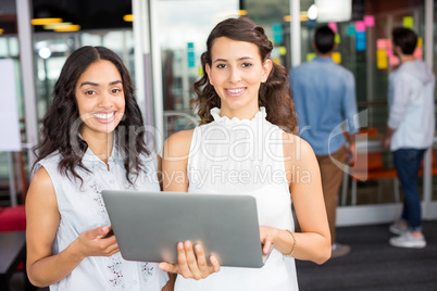 Portrait of happy female executives using laptop Portrait of happy female executives using laptop