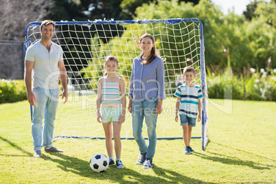 Family playing football together at the park