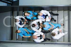 High angle view of doctors and surgeons sitting on staircase