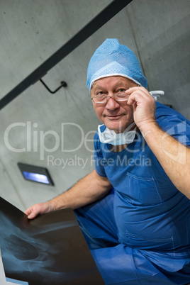 Portrait of male surgeon examine x-ray on stairs