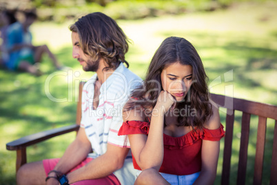 Couple ignoring each other in park