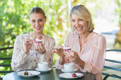 Smiling friends enjoying coffee together