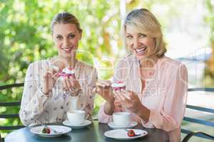 Smiling friends enjoying coffee together