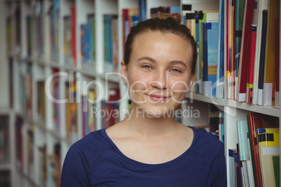 Portrait of smiling schoolgirl smiling in library