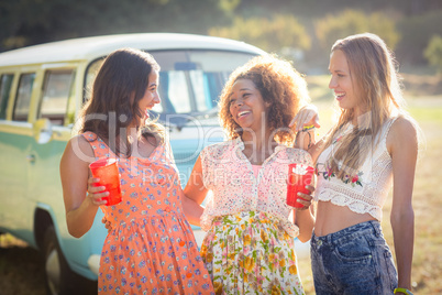 Female friends interacting with each other in park