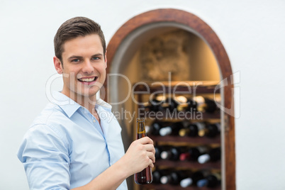 Handsome man holding beer bottle