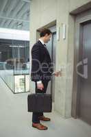 Businessman waiting for an elevator