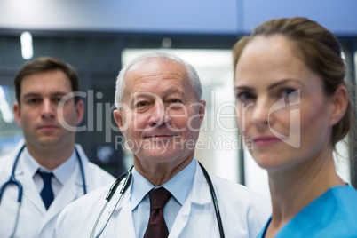 Smiling doctors and surgeon standing together in hospital Smiling doctors and surgeon standing together in hospital