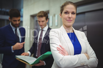 Portrait of beautiful businesswoman standing with arms crossed