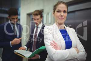 Portrait of beautiful businesswoman standing with arms crossed