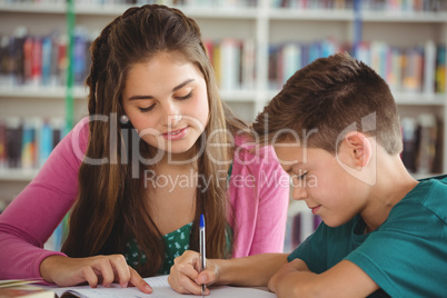 School kids doing homework in library at school