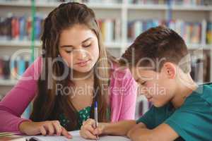 School kids doing homework in library at school