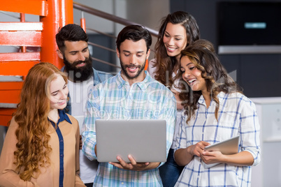 Happy executives having discussion over laptop