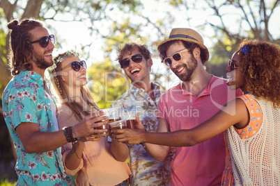 Group of friends toasting glasses of beer
