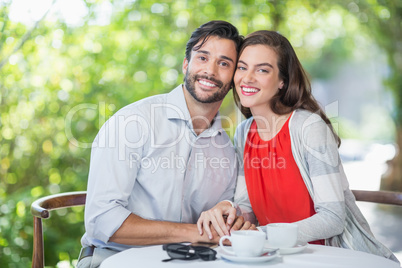 Happy couple holding each others hands in the restaurant