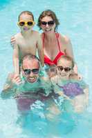 Happy parents and kids in pool