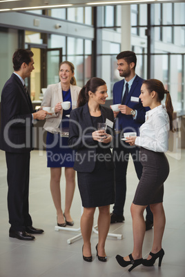 Group of businesspeople interacting with each other in the lobby